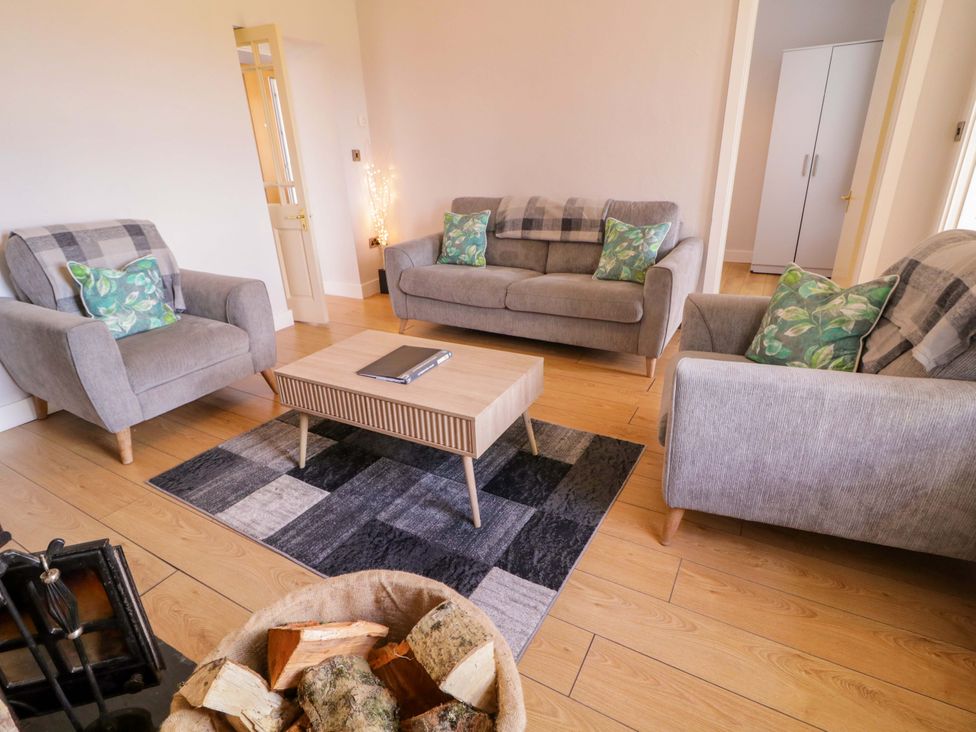 A living room with sofas and a coffee table at Molly's Cottage in Enniskillen