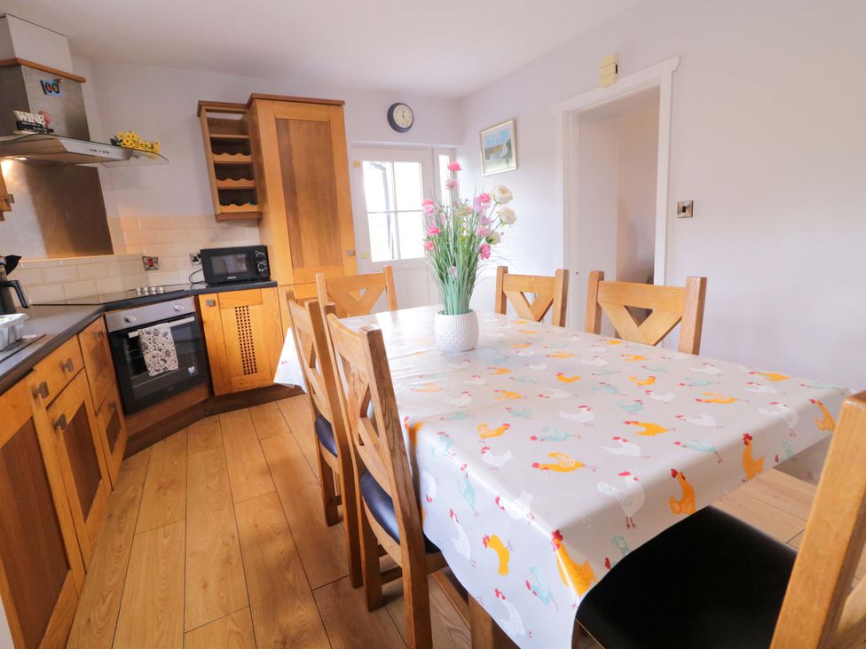A kitchen with a dining table and chairs at Molly's Cottage in Enniskillen
