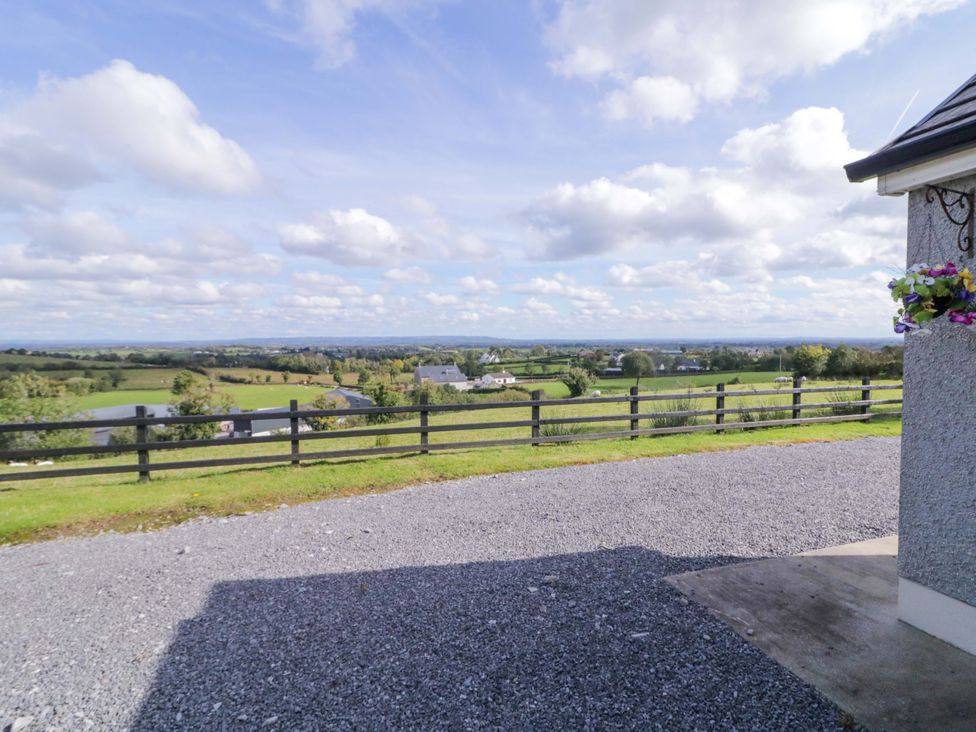 A view of a landscape with grass and a fence at Molly's Cottage Enniskillen