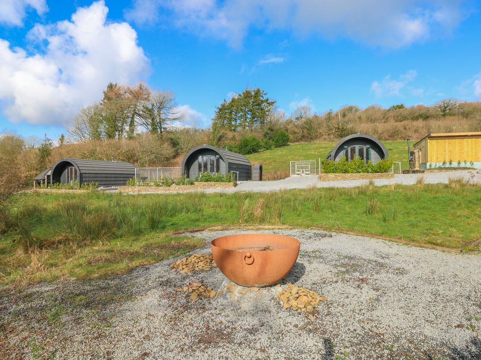 Outdoor area with cabins and a fire pit at Lodge 1 near Pontyates