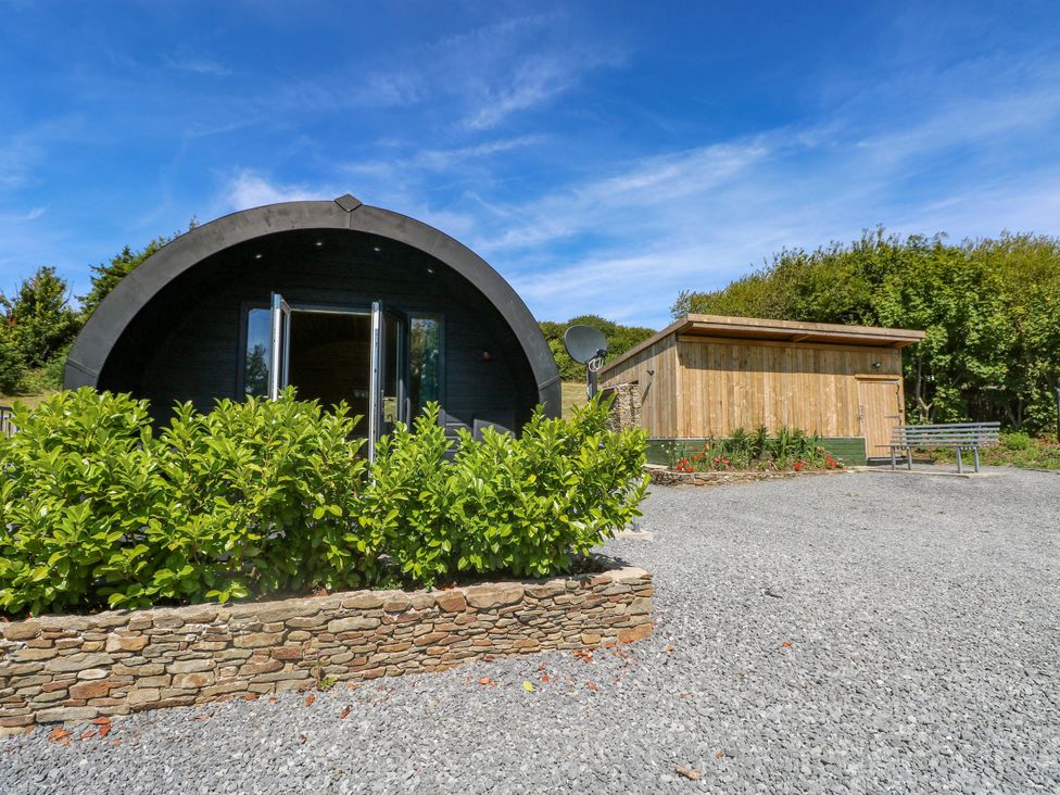 An outdoor area with buildings and plants at Thelma’s Lodge near Pontyates