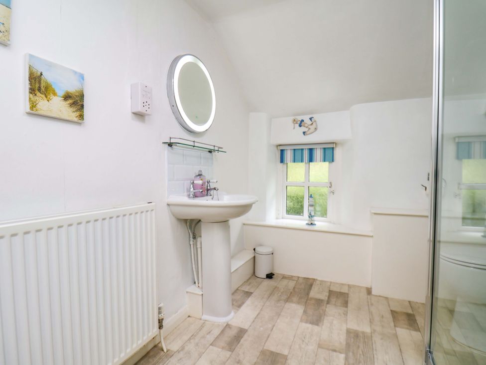 A bathroom with a sink and shower at 5 Hollins Cottages in Whitby