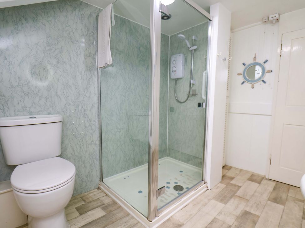 A bathroom with a shower and toilet at 5 Hollins Cottages in Whitby