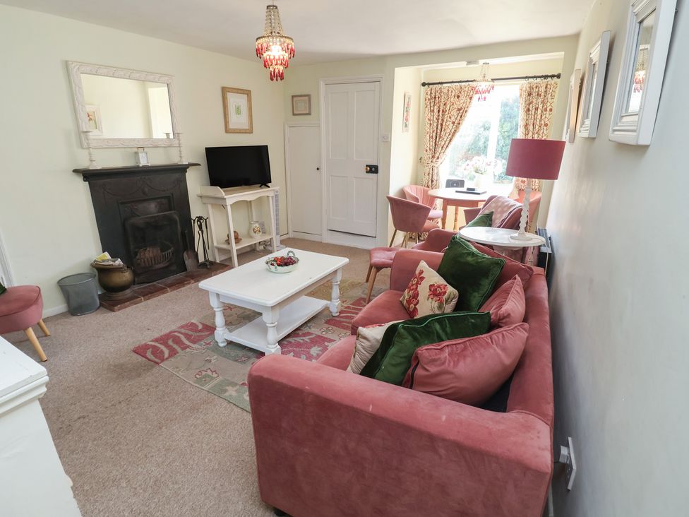 A living room with a sofa and coffee table at Pebble in Blakeney, Norfolk