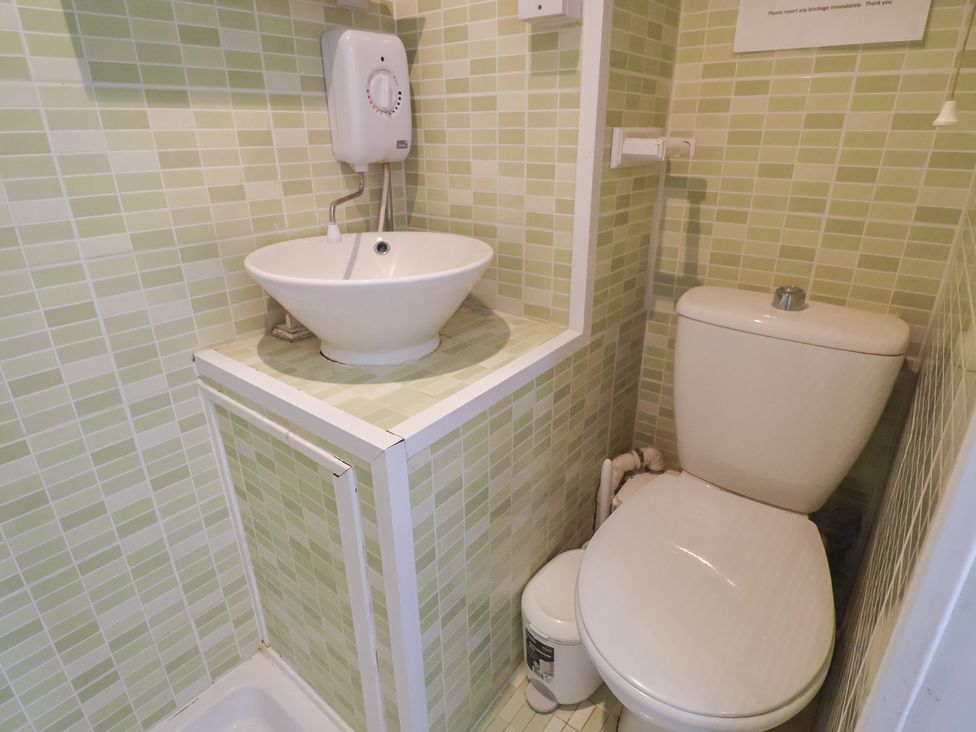 A bathroom with a sink and toilet at Pebble, Blakeney, Norfolk