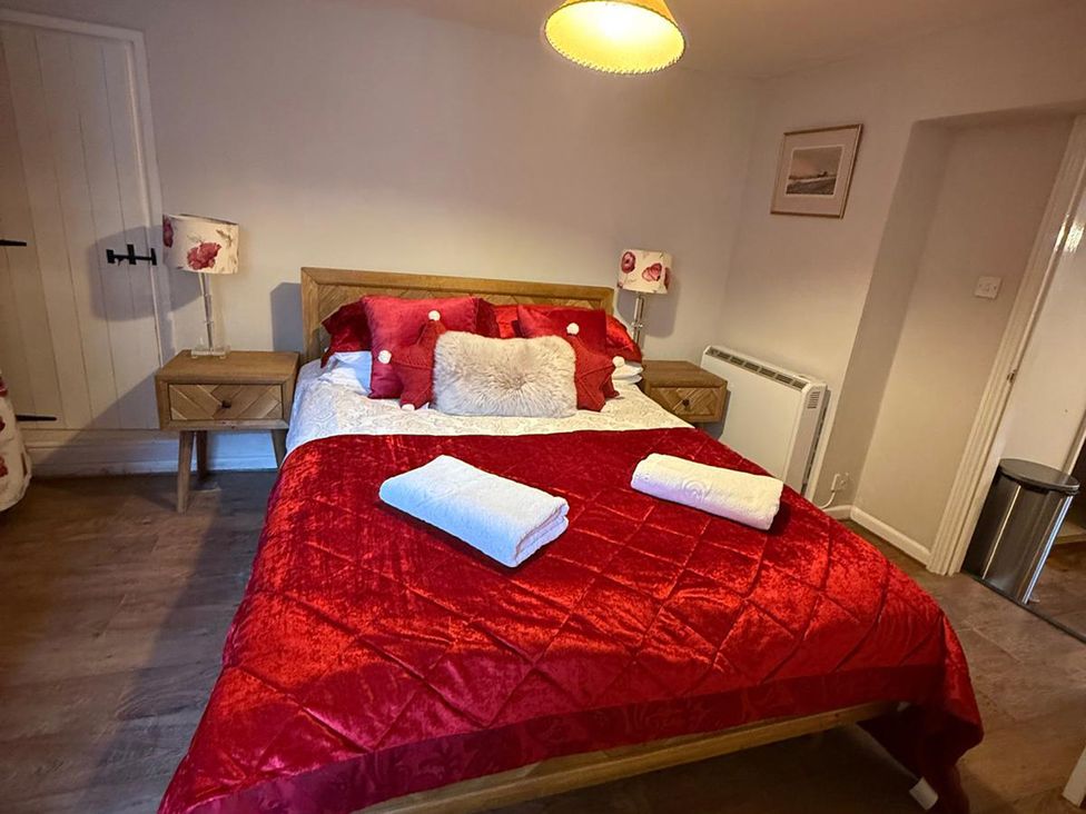 A bedroom with a double bed and bedside tables at The Bittern in Blakeney, Norfolk