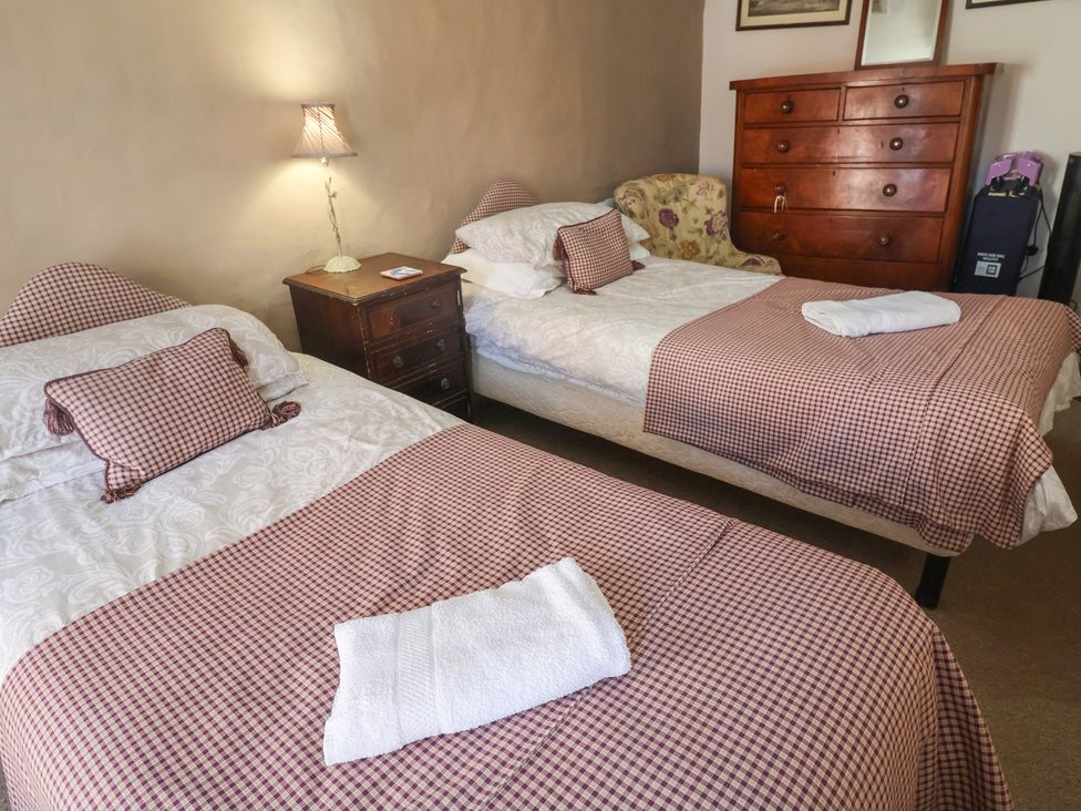 A bedroom with two beds and furniture at The Plover in Blakeney, Norfolk