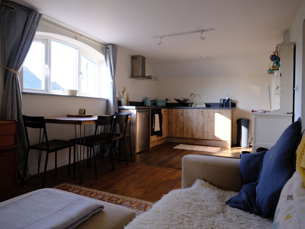 A kitchen with a dining table and chairs at The Hideaway in Tintagel