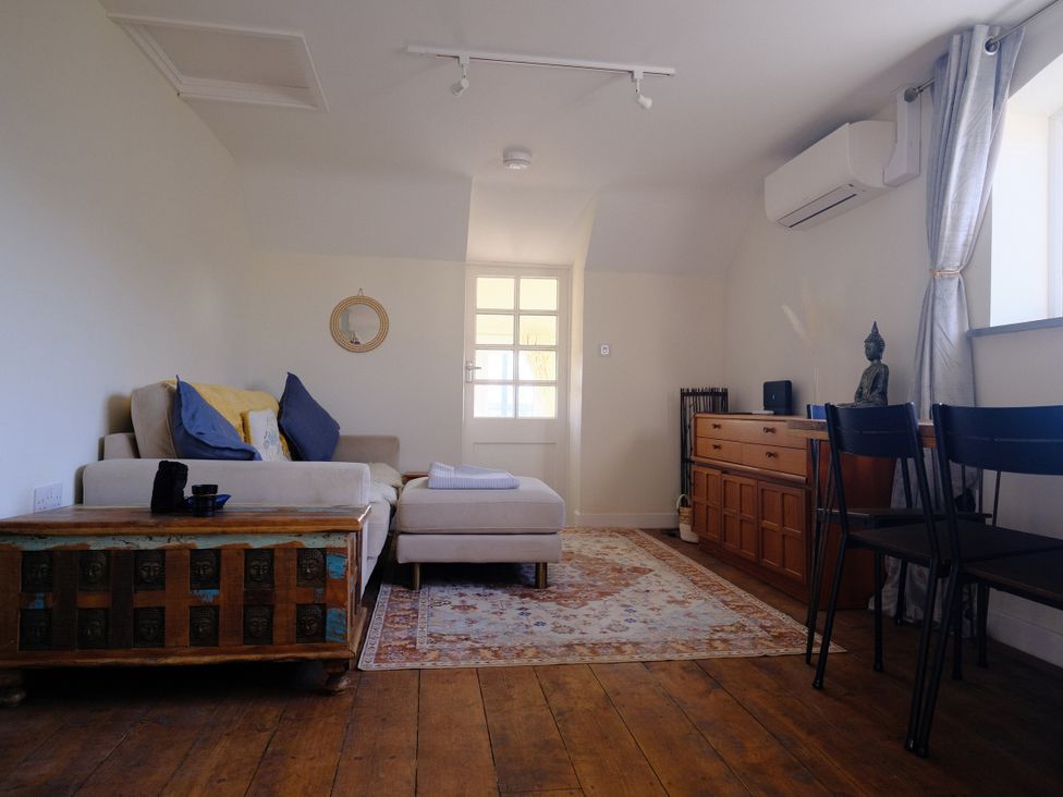 A living room with a sofa and coffee table at The Hideaway in Tintagel