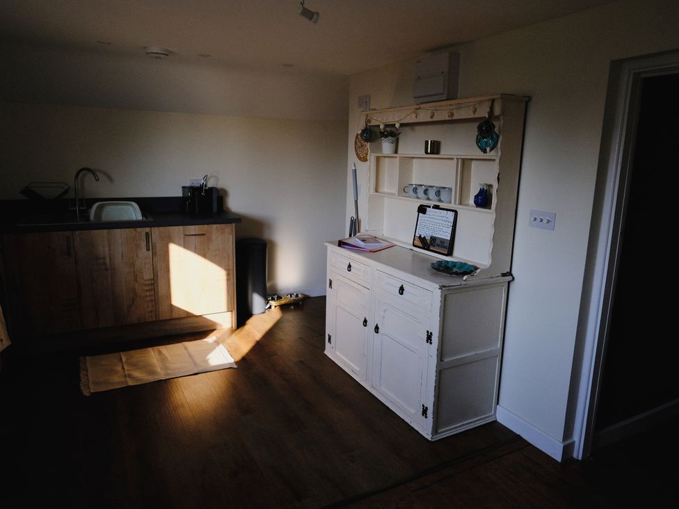 A kitchen with cabinetry and sink at The Hideaway in Tintagel
