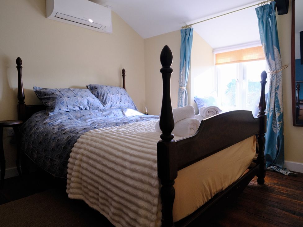 A bedroom with a bed and pillows at The Hideaway in Tintagel