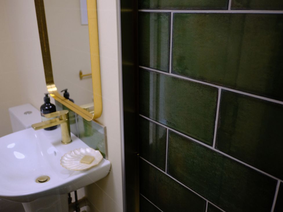 A bathroom with a sink and a mirror at The Hideaway in Tintagel