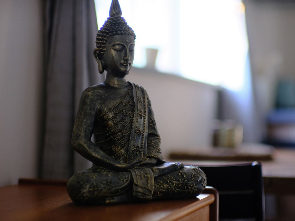 A buddha statue on a table at The Hideaway in Tintagel