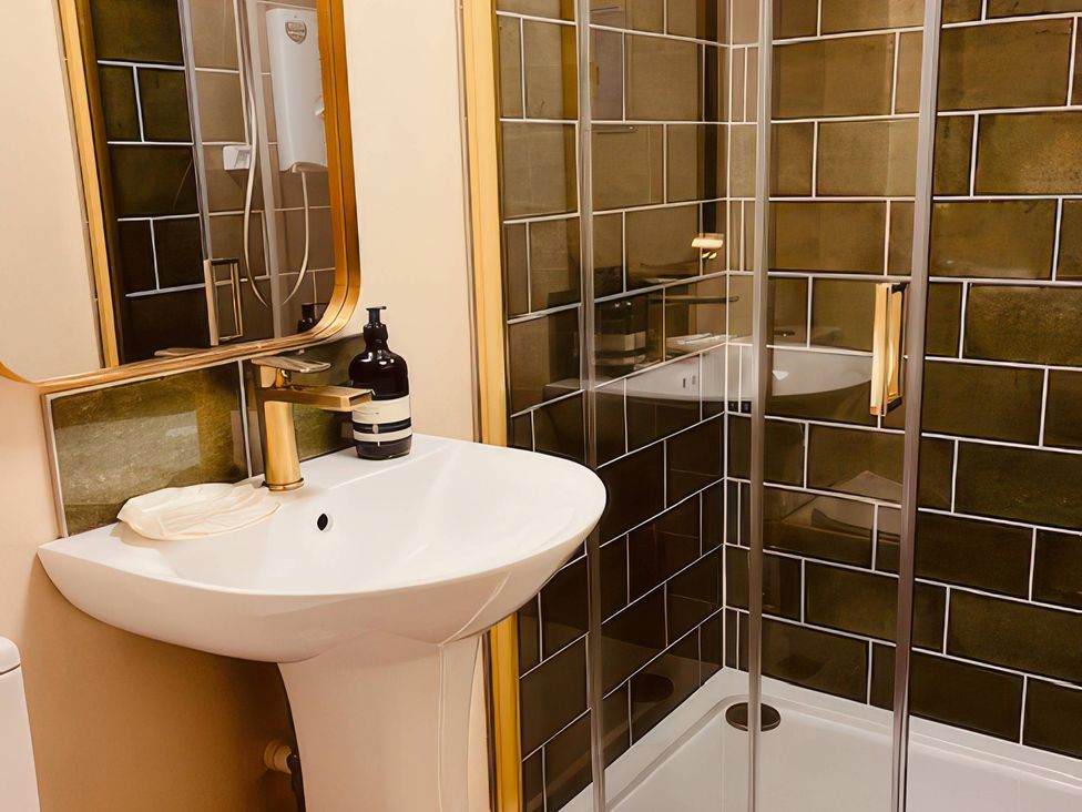 A bathroom with a sink and shower at The Hideaway in Tintagel