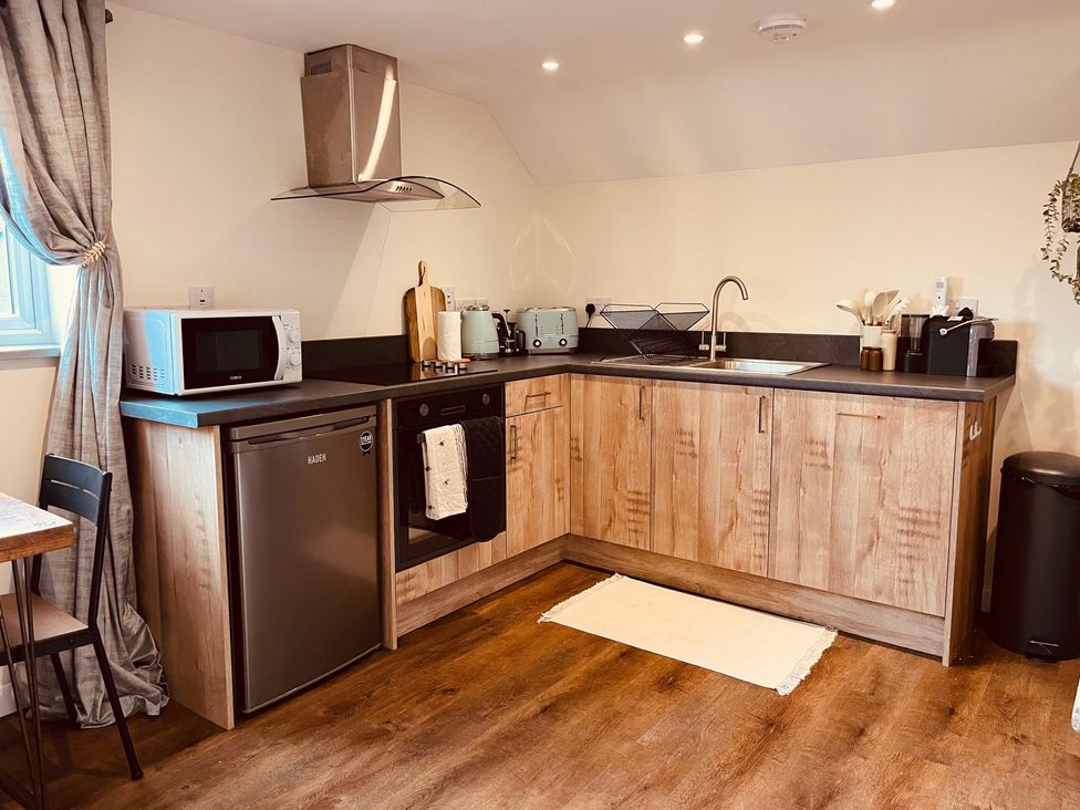 A kitchen with countertop and appliances at The Hideaway in Tintagel
