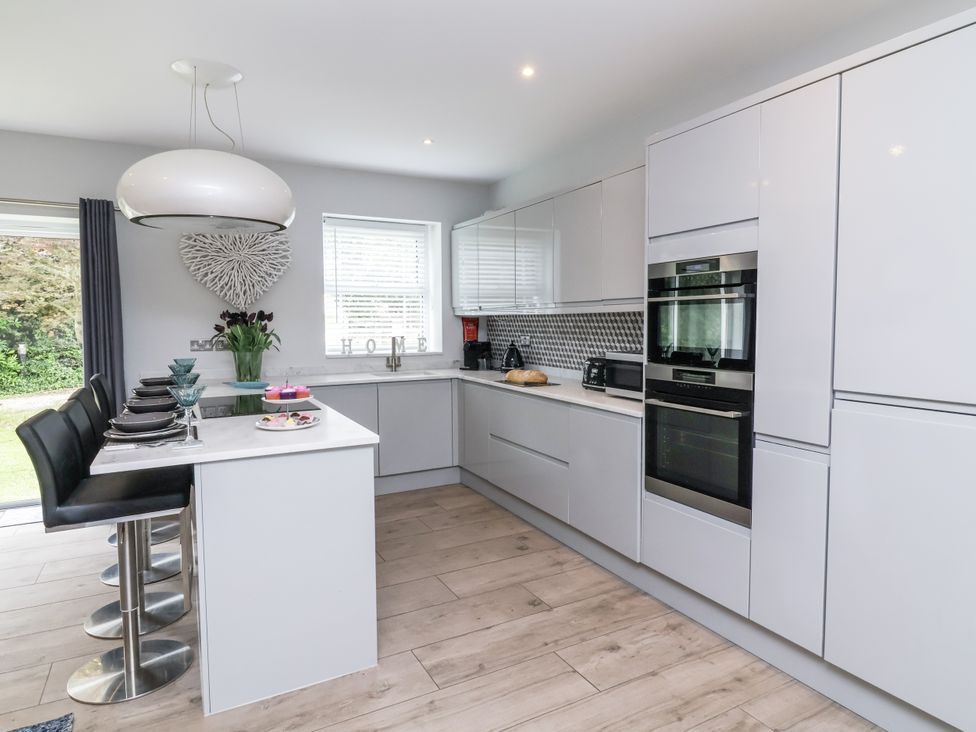 A kitchen with cabinets and appliances at Beach Hideaway
