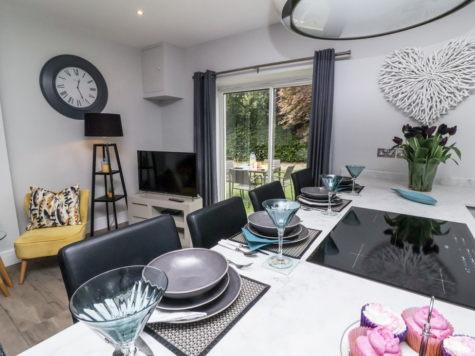 A kitchen with a dining table and chairs at Beach Hideaway
