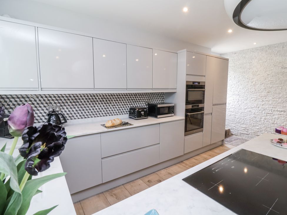 A kitchen with cabinets and appliances at Beach Hideaway