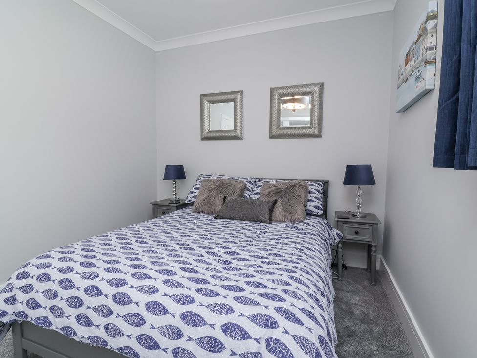 A bedroom with a bed and two bedside tables at Beach Hideaway