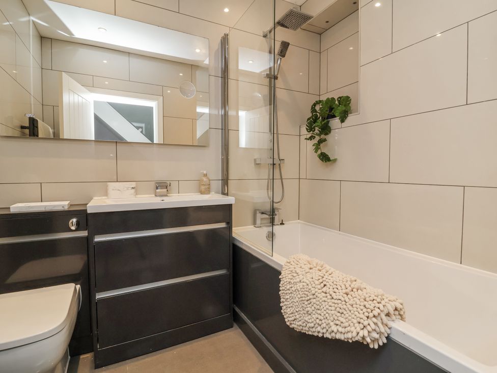 A bathroom with a bathtub and a sink at Beach Hideaway