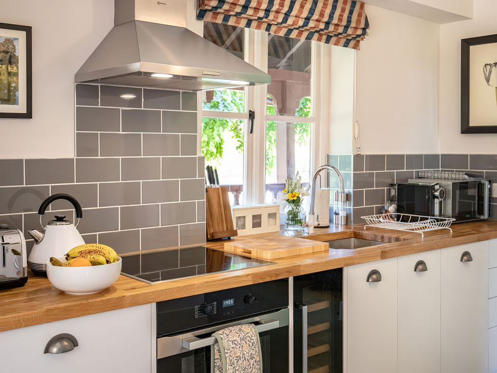 A kitchen with a sink and cooktop at Dairy Cottage in Waddeston