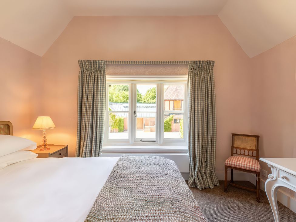 A bedroom with a bed and a window at Dairy Cottage in Waddeston