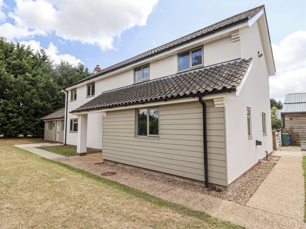 A house exterior with windows and a pathway at Holly Farm Colchester