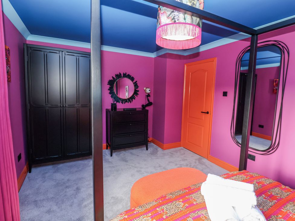 A bedroom with a bed and wardrobe at Holly Farm in Brantham