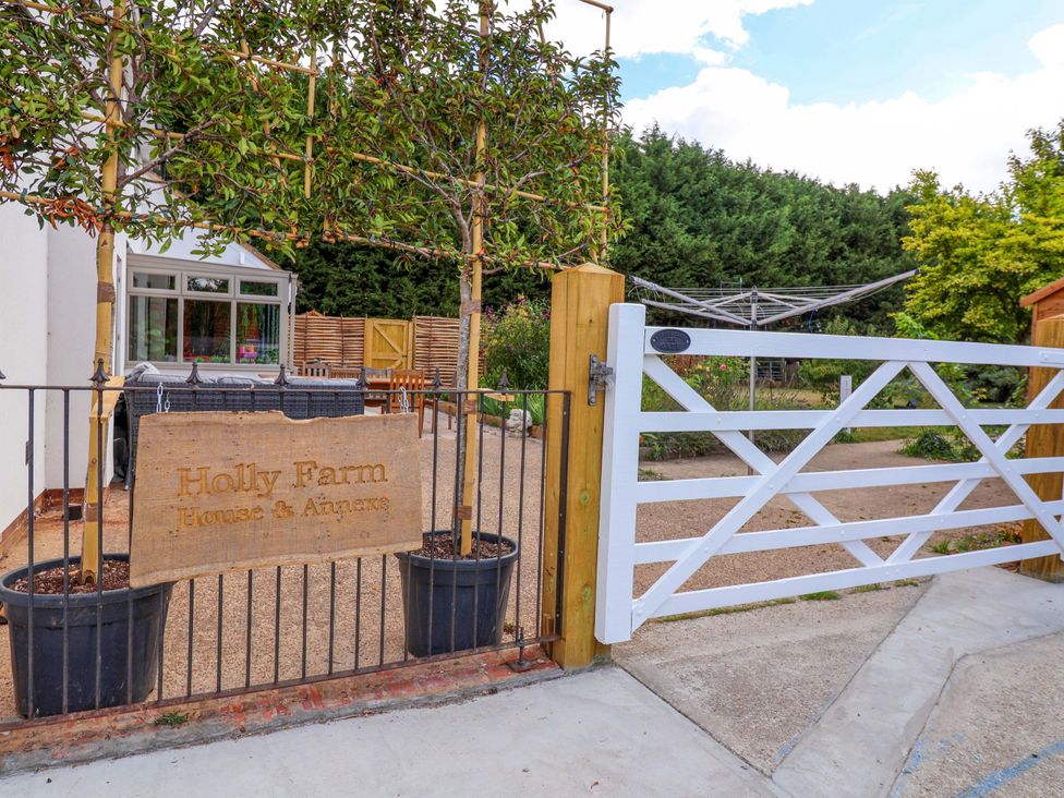 An outdoor area with a sign and gate at Holly Farm in Brantham