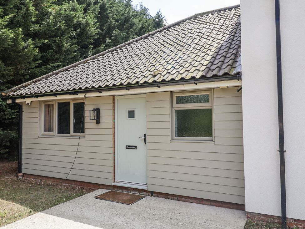 An entrance to a property with a front door and windows at Annexe in Colchester