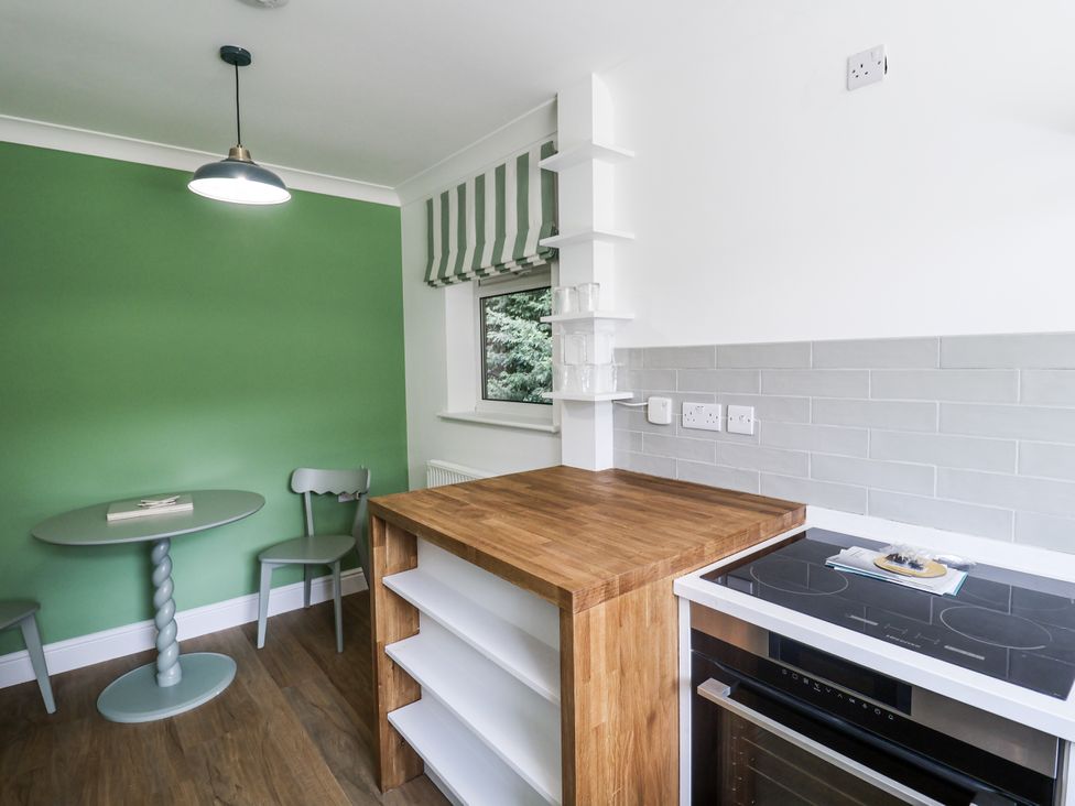 A kitchen with a table and chairs at Annexe in Colchester