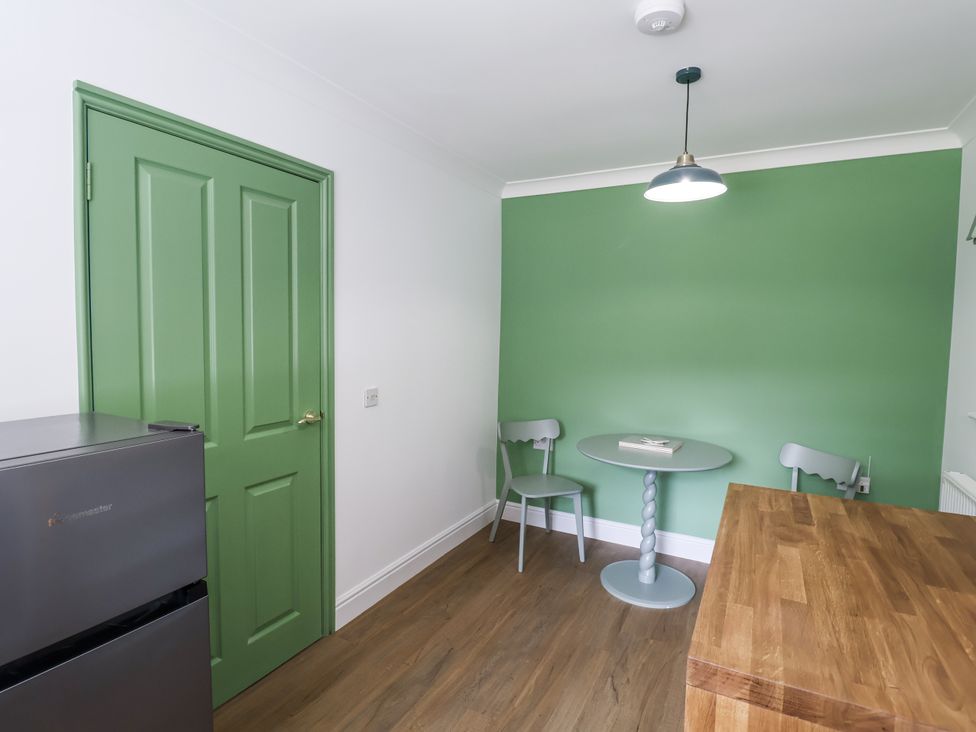 A kitchen with a table and chairs at Annexe, Colchester
