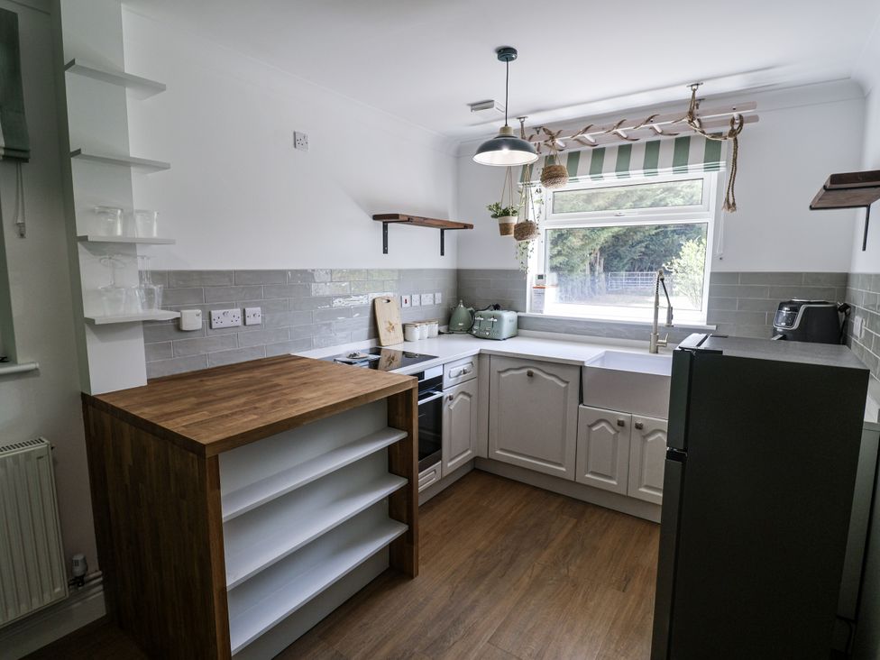 A kitchen with sink and oven at Annexe in Colchester