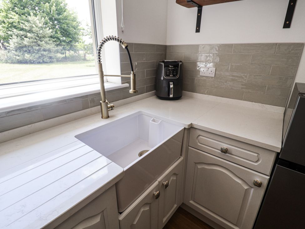 A kitchen with a sink and air fryer at Annexe in Colchester