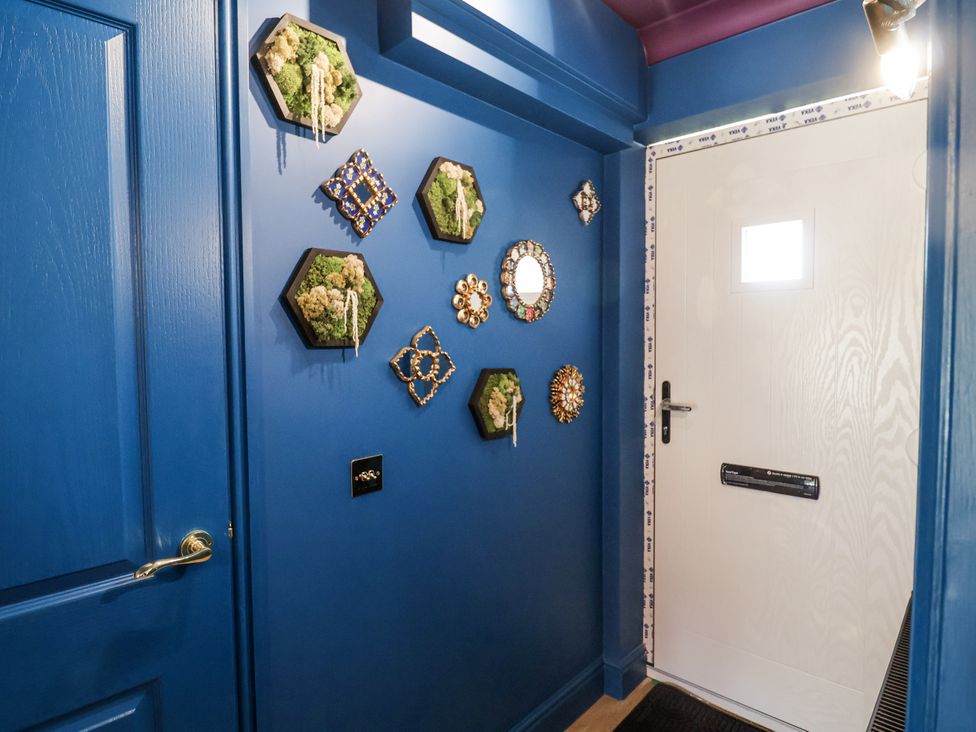 An entryway with decorative wall art and a door at Annexe in Colchester