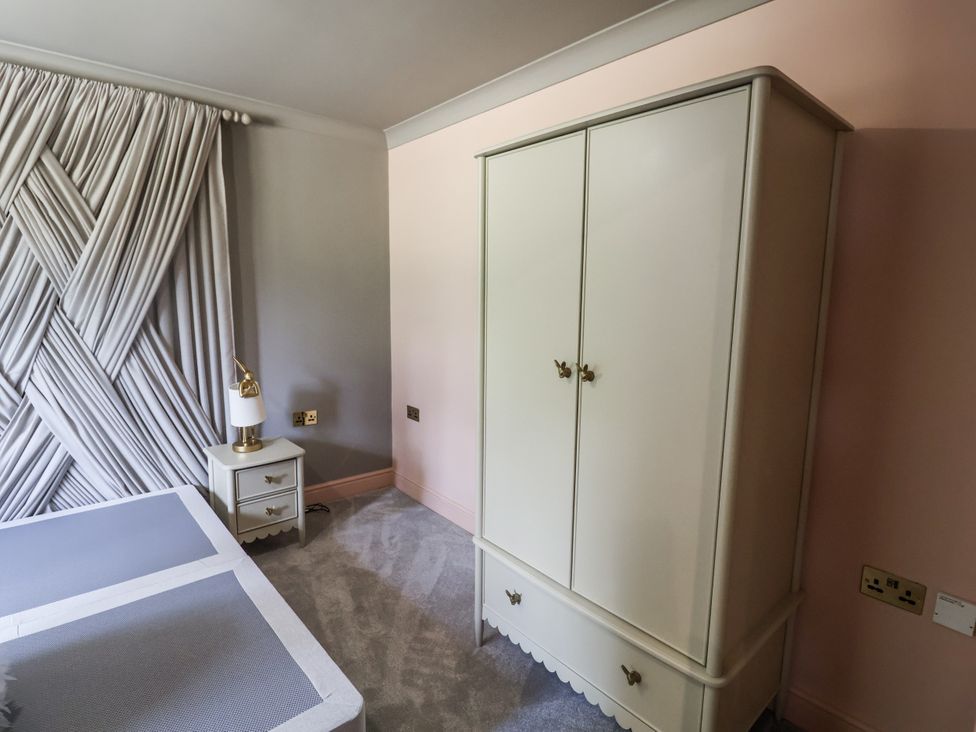 A bedroom with a bed and a wardrobe at Annexe in Colchester