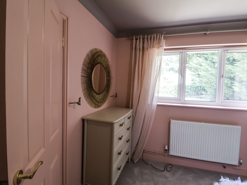 A bedroom with a dresser and a window at Annexe in Colchester