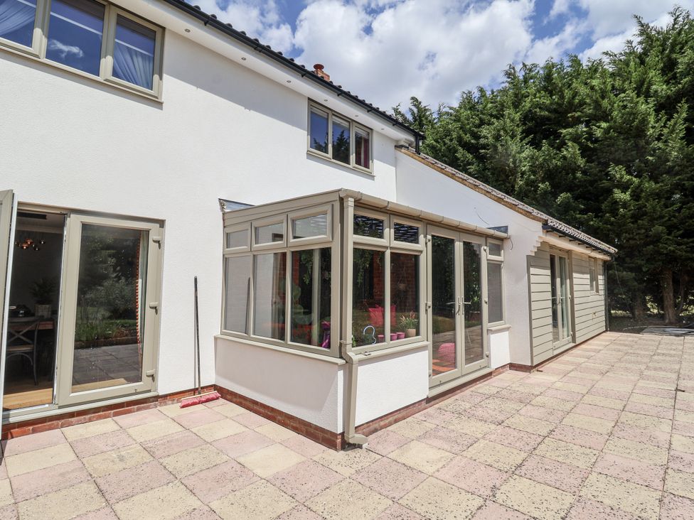 An outdoor view of a property featuring a patio and conservatory at Annexe, Colchester
