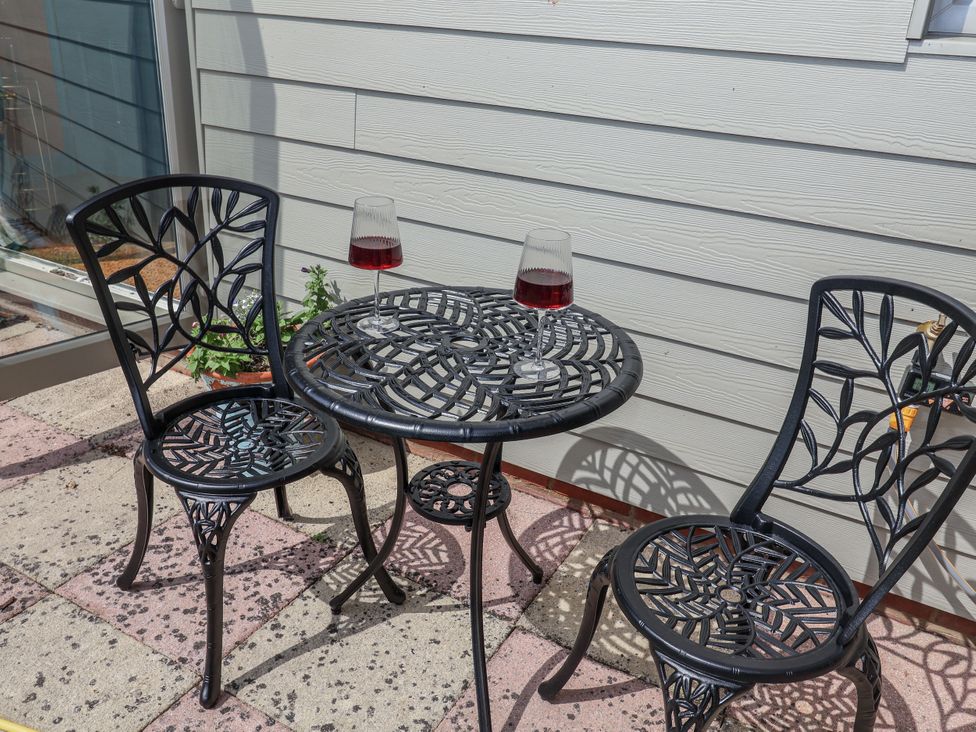 A table with two chairs and glasses on it at Annexe East End near Brantham
