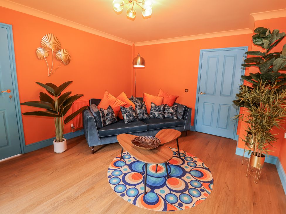 A living room with a blue sofa and a coffee table at Annexe in East End near Brantham