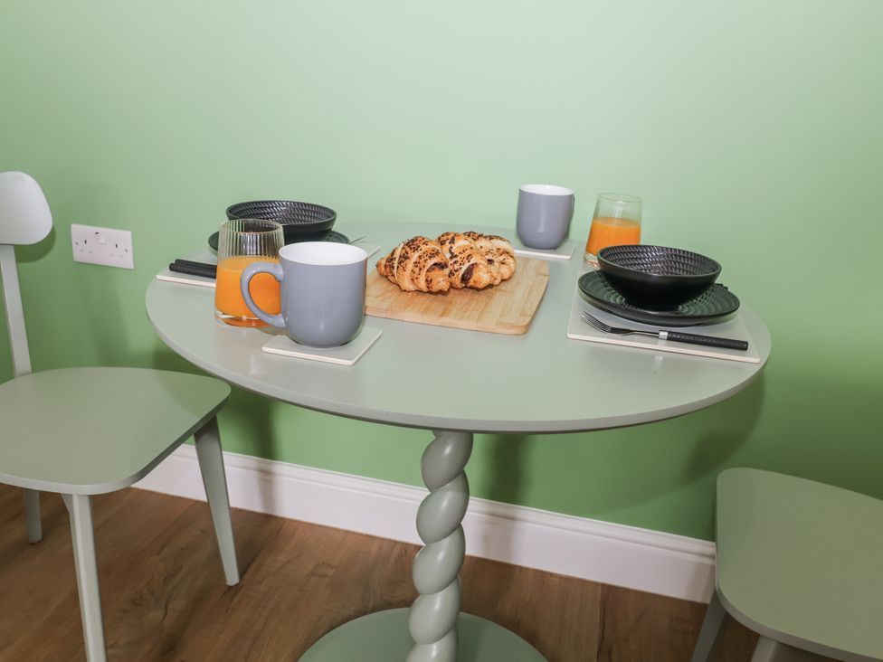 A dining table with croissants and drinks at Annexe, East End near Brantham