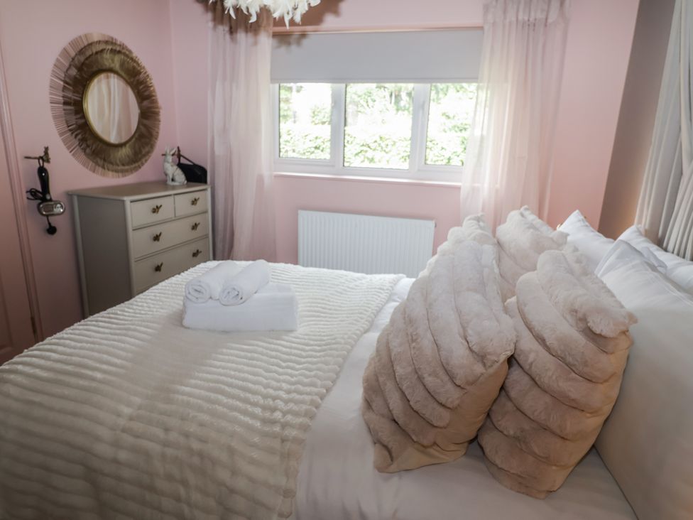 A bedroom with a bed and dresser at Annexe East End near Brantham
