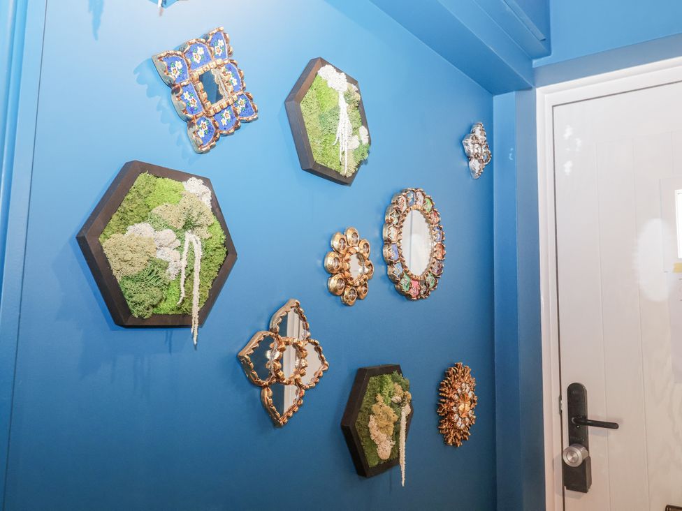 Decorative wall art with various shapes on a blue wall at Annexe East End near Brantham