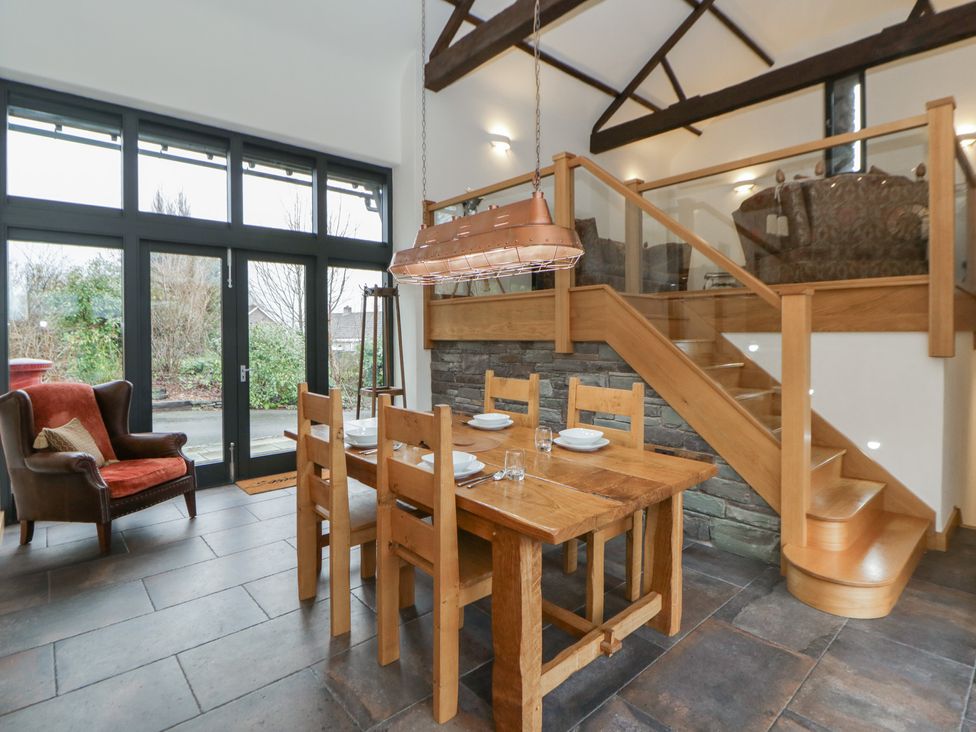 A dining room with a table and chairs at The Barn at Sunny Barn Brecon