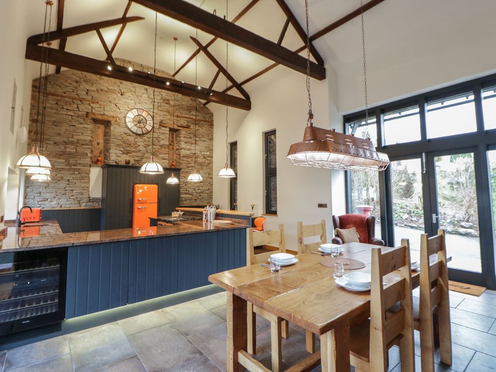 A kitchen with a large table and chairs at The Barn at Sunny Barn in Brecon