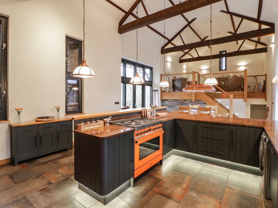 A kitchen with an island and stove at The Barn at Sunny Barn in Brecon