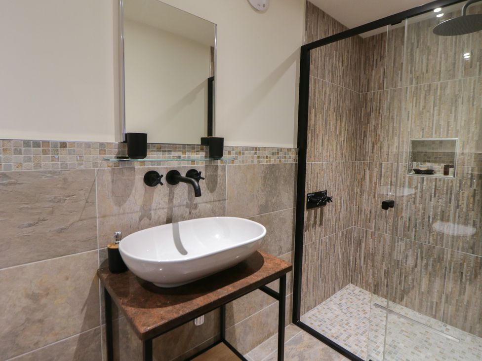 A bathroom with a sink and shower at The Barn at Sunny Barn in Brecon