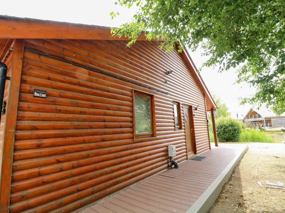 A log cabin exterior with a door and window at Sunnyside Lodge Thorpe-On-The-Hill