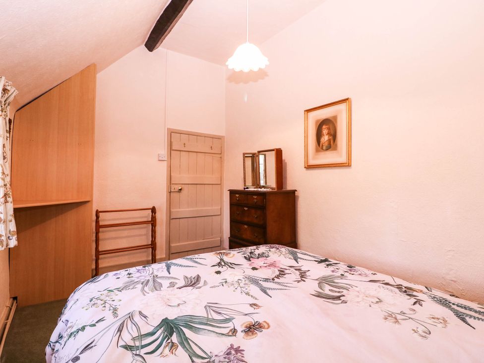 A bedroom with a bed and furniture at Vine Cottage in Cheltenham