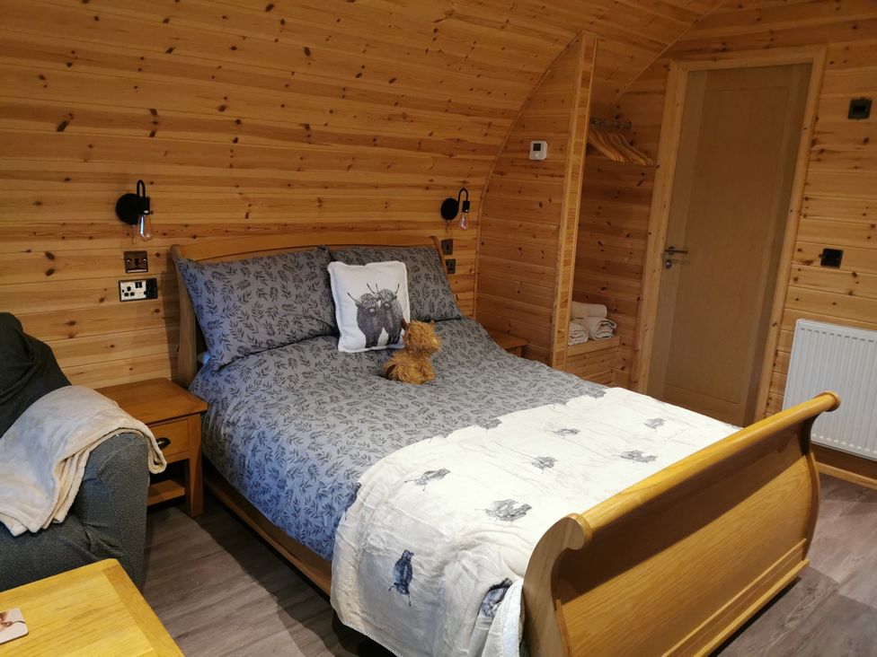 A bedroom with a bed and teddy bear at Lodge 3 in Pontyates